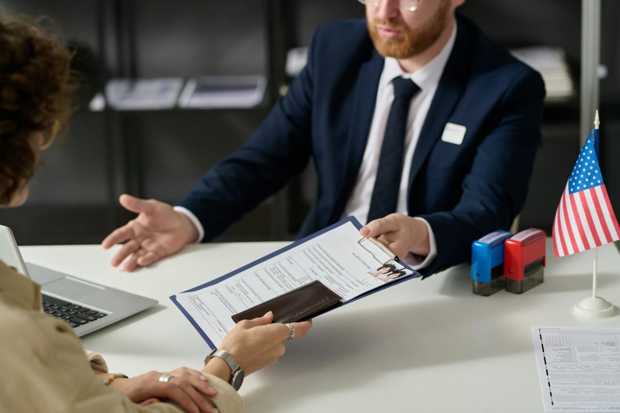 close-up-of-woman-handing-visa-application.jpg